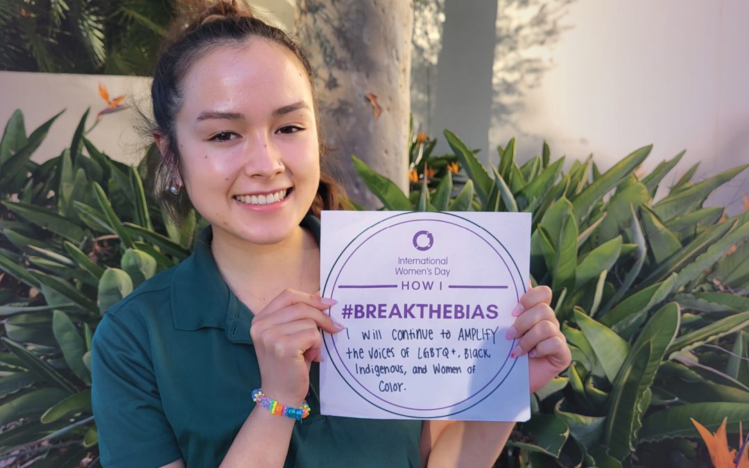 Cal Poly International Center student employee displays a card on how she will "Break the Bias" for International Women's Day
