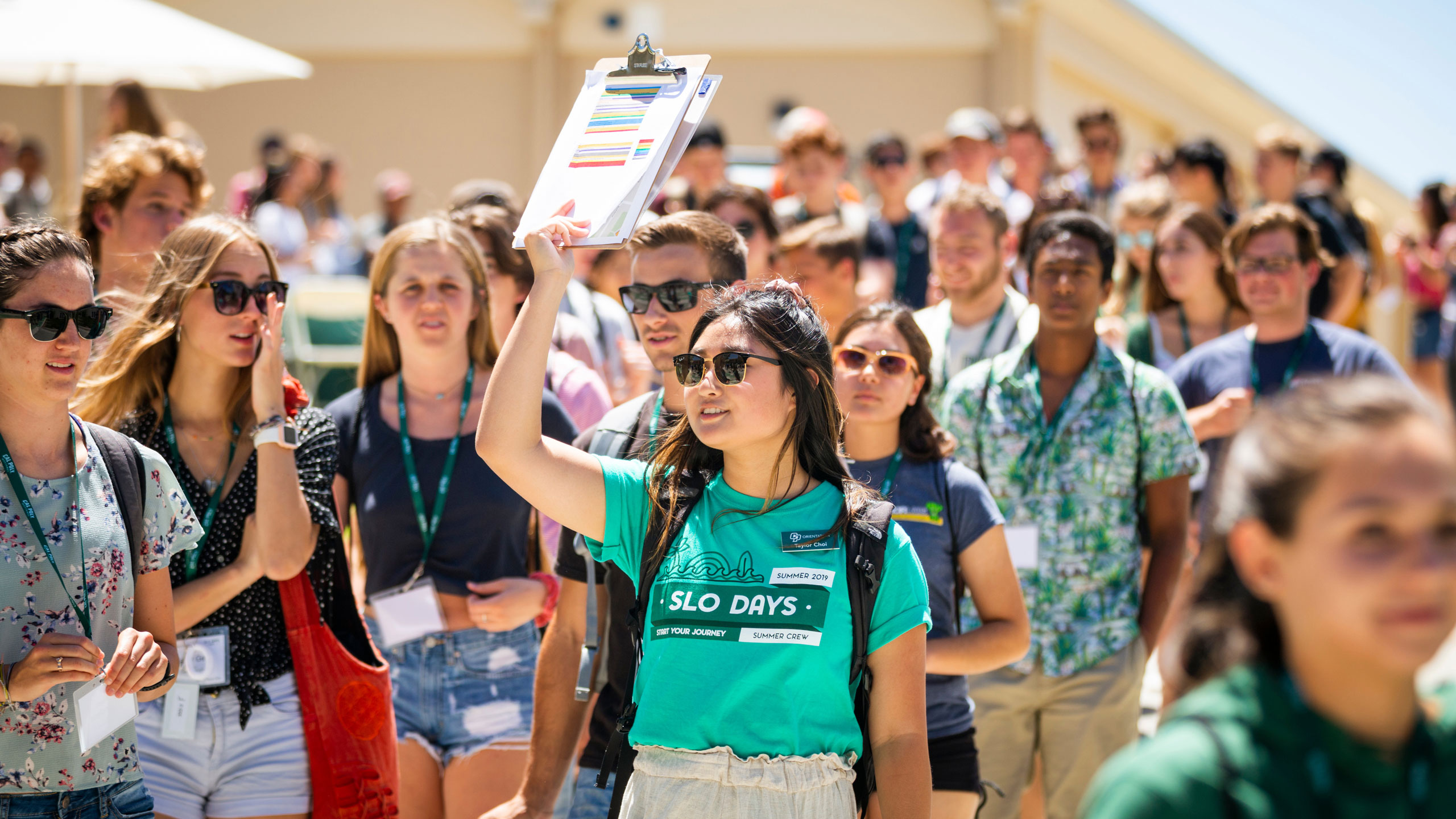 female student holds up a clipboard at SLO Days, Cal Poly's 2-day, overnight, summer orientation