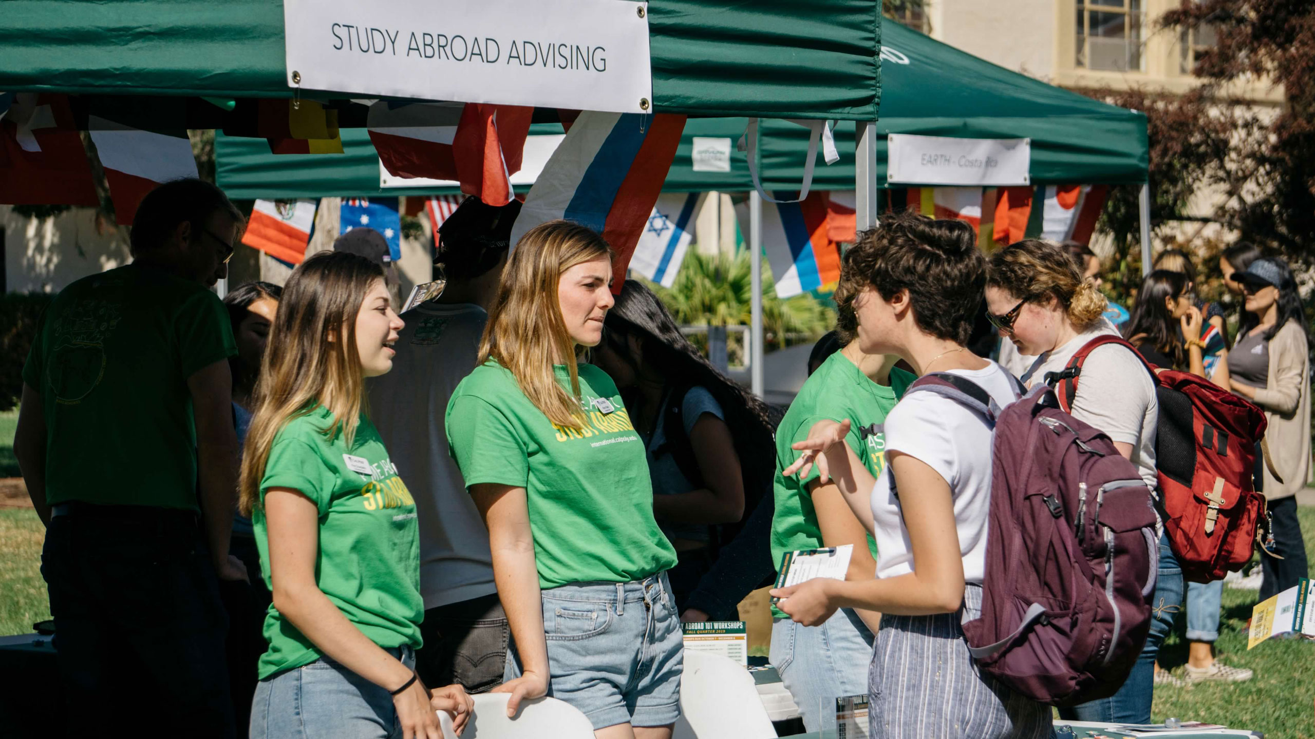 2019 Study Abroad Fair, student interns discuss study abroad programs with attendees.