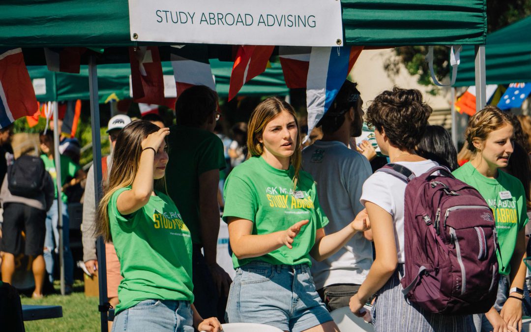Study Abroad Peer Advisors provide information to Cal Poly students at a past study abroad fair.