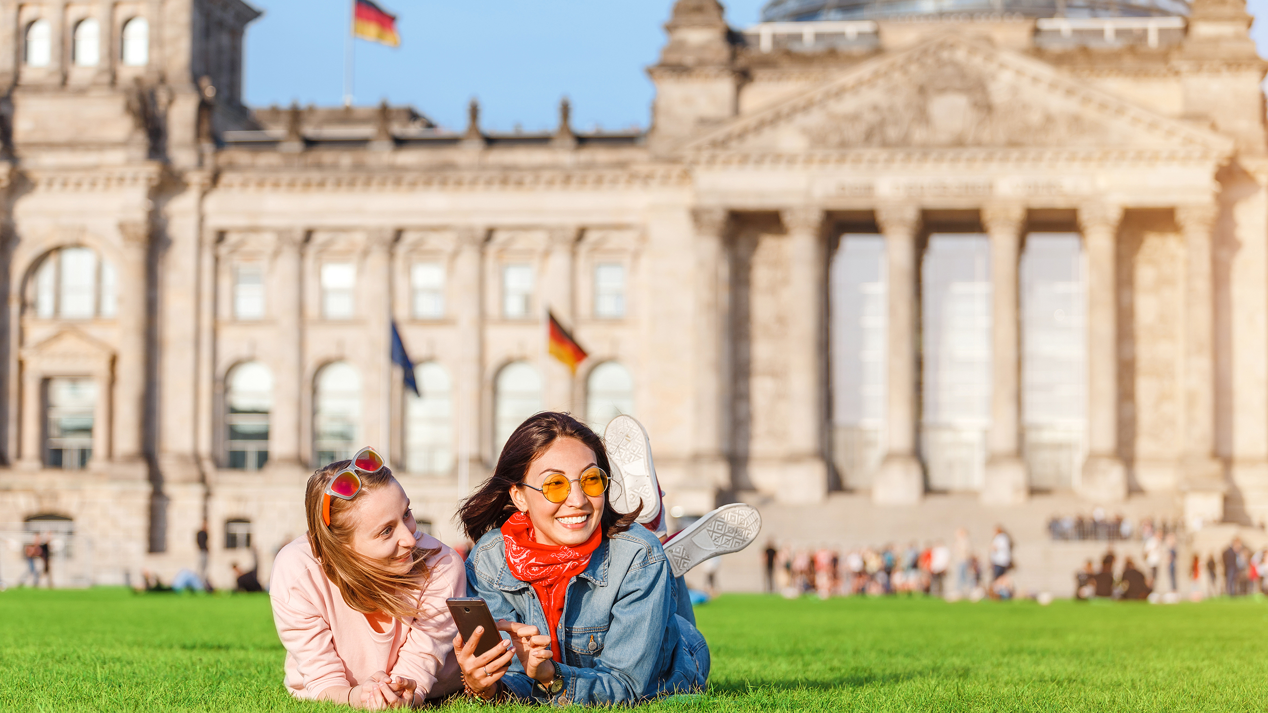 Two students studying abroad. Relaxing in front of the Bundestag building in Berlin.