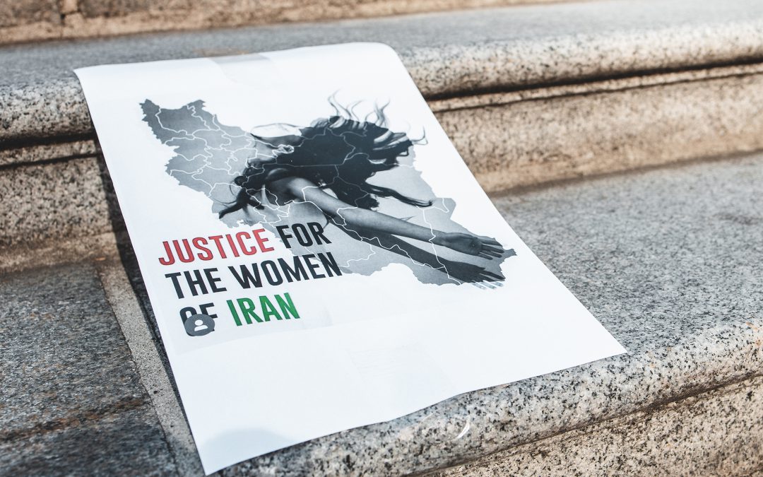 Rally in support of Iranian protests. View of sign justice for women in Iran