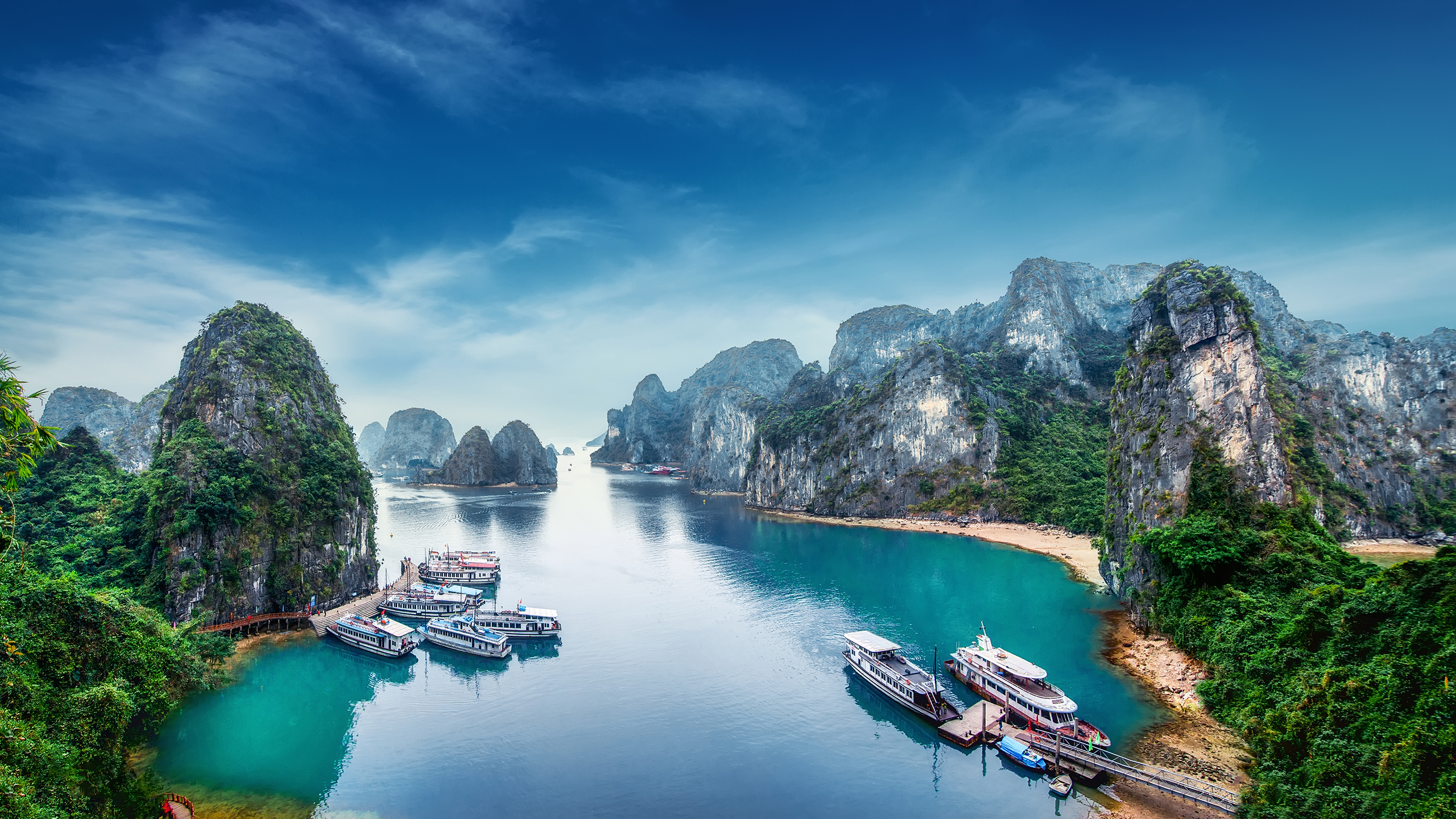 Tourist junks floating among limestone rocks at Ha Long Bay, South China Sea, Vietnam