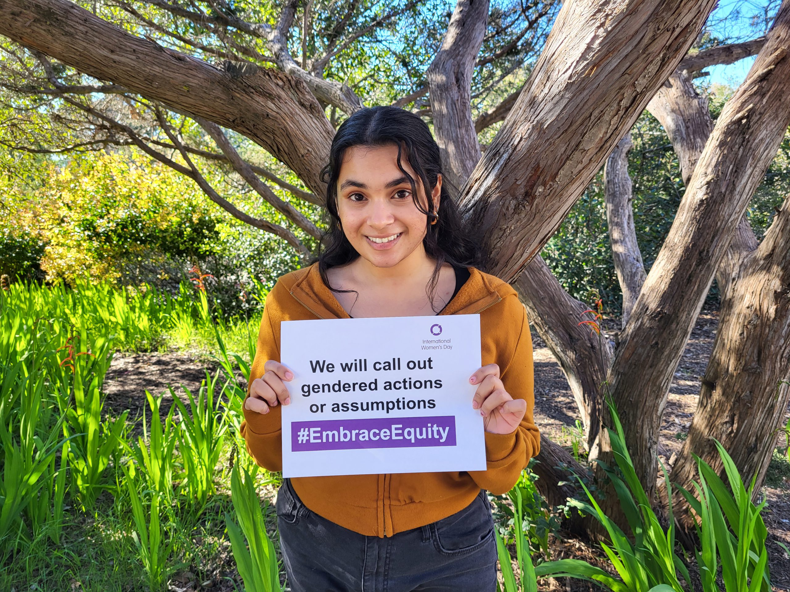 Woman holding an International Women’s Day sign