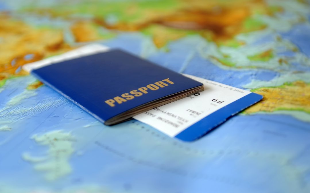 Passport and ticket on a background map of the world.