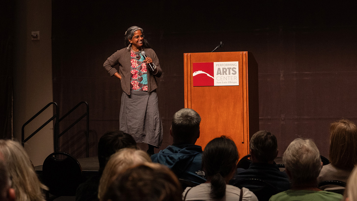 Someone speaking on a stage in front of an audience