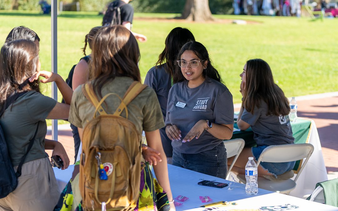 Students speaking at a booth