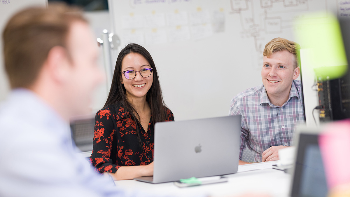 Picture of students with a computer attending a workshop