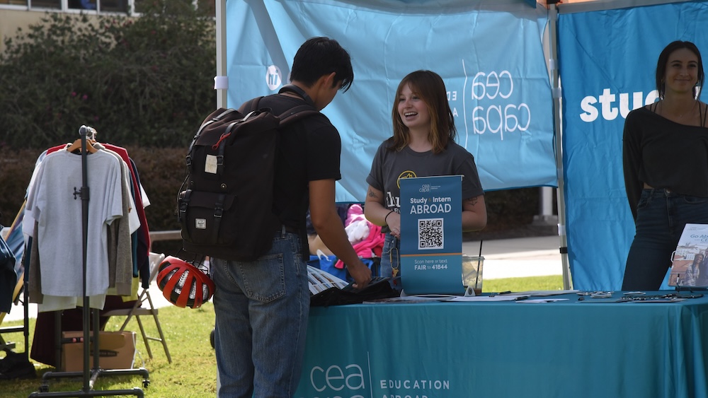 Students speaking at a booth