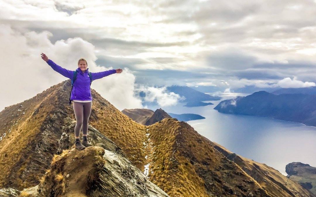 Woman on top of a mountain